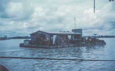 Dong Nai 9/18/1969  Our Divers barge, taken from the other barge.  We are salvaging a helicopter that crashed here.  It is in between the two barges.